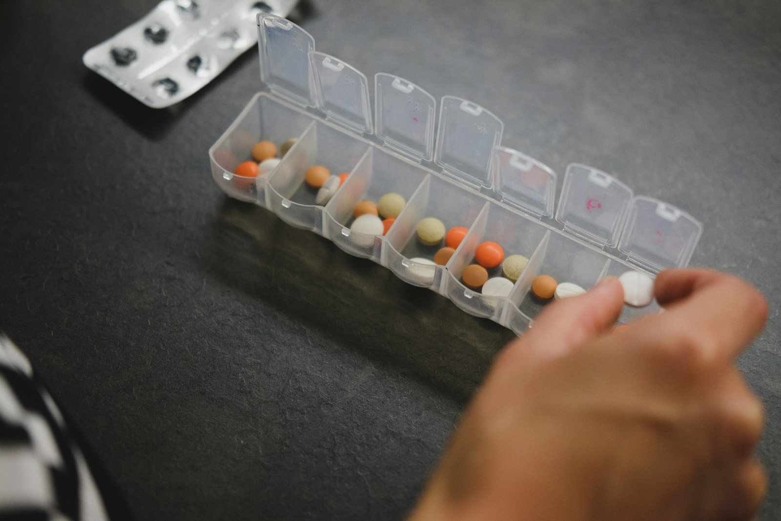 Medication organizer and pill schedule setup for senior recovery