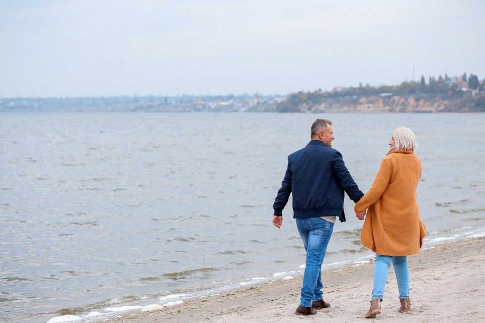 An older couple walking outdoors together, staying active and independent